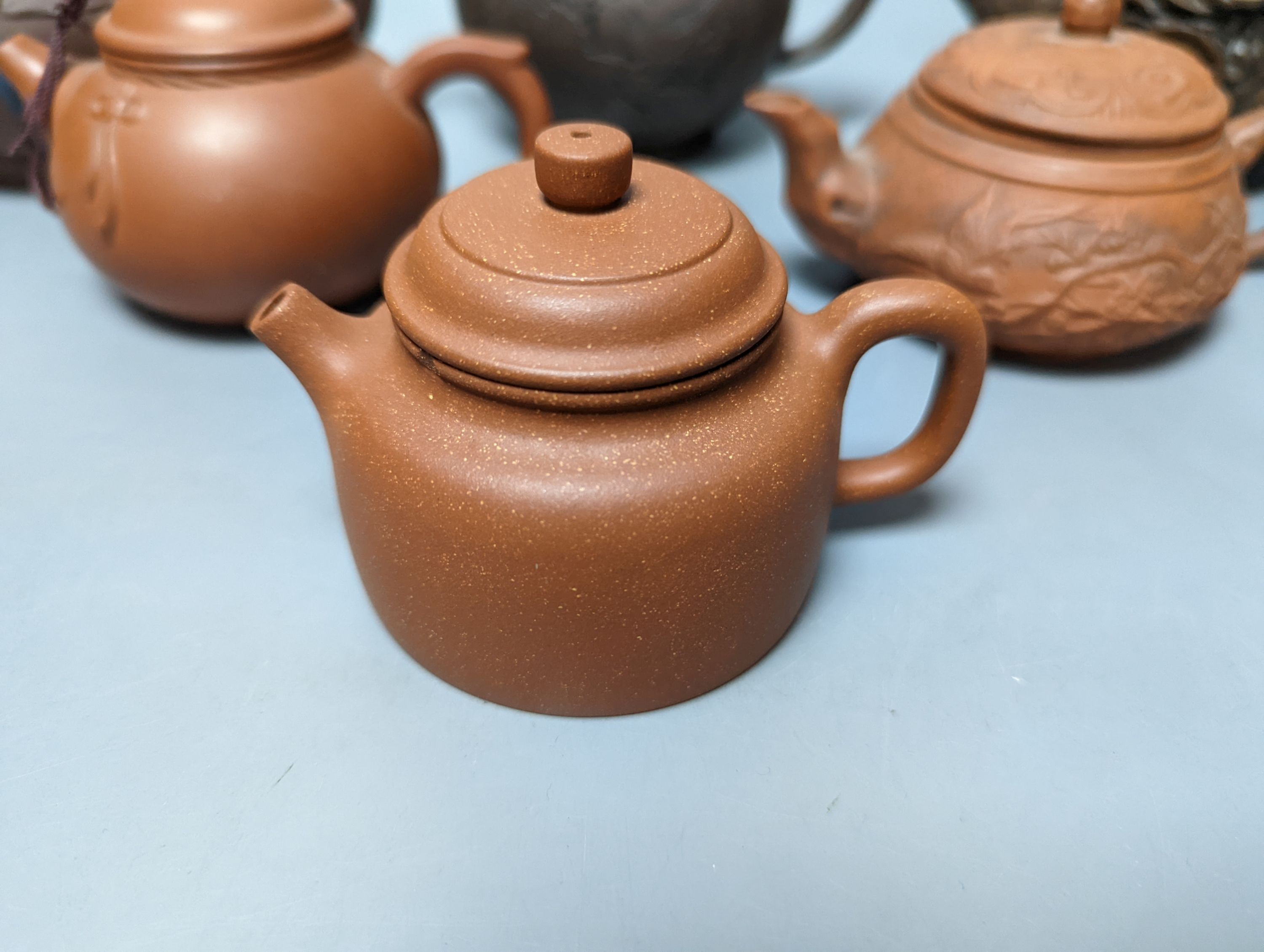 A Chinese stoneware 'cash' teapot and cover and five Yixing teapots (6)